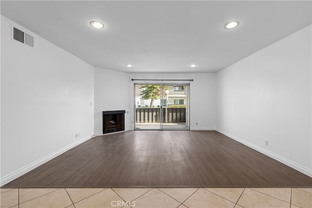 unfurnished living room with light tile patterned flooring