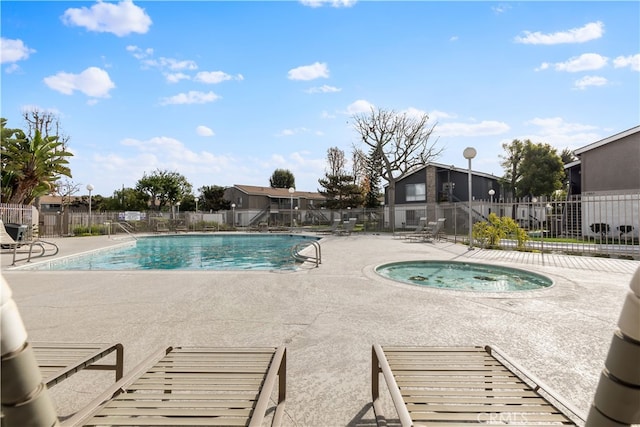 view of pool with a patio and a community hot tub