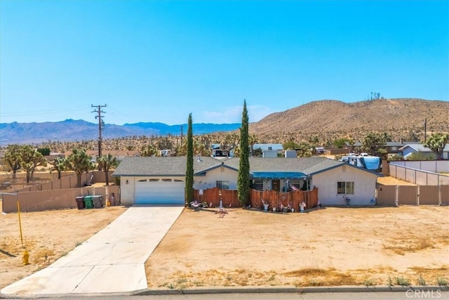 view of front of house with a garage and a mountain view