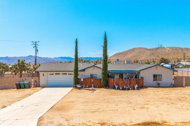 ranch-style house featuring a mountain view and a garage