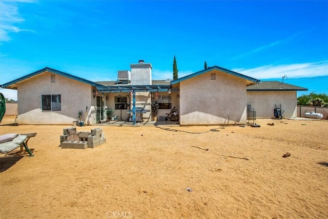 rear view of house featuring a pergola and a patio