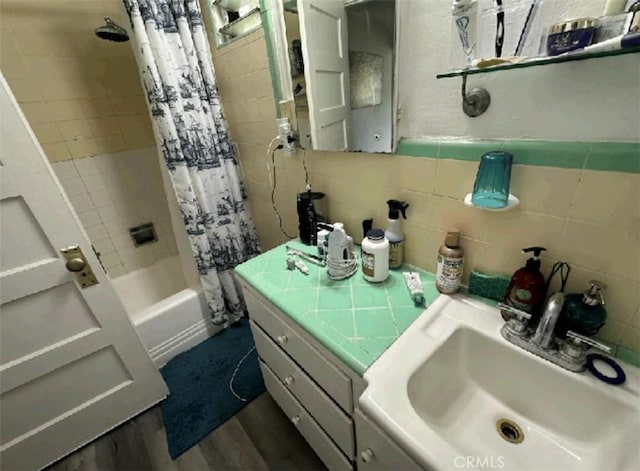 bathroom featuring shower / bath combo with shower curtain, hardwood / wood-style flooring, and vanity