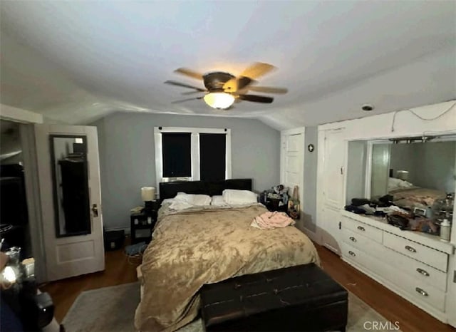 bedroom with ceiling fan, dark hardwood / wood-style flooring, and vaulted ceiling