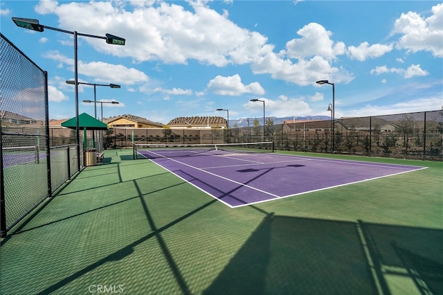 view of tennis court featuring basketball court