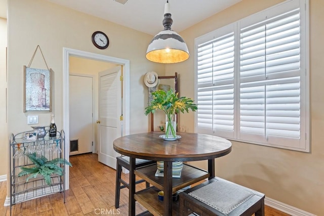 dining space with hardwood / wood-style floors