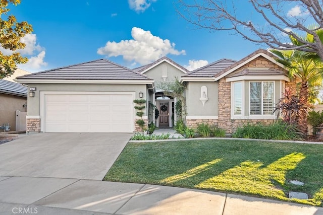 view of front of home with a front yard and a garage