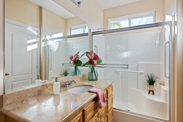 bathroom featuring vanity and an enclosed shower