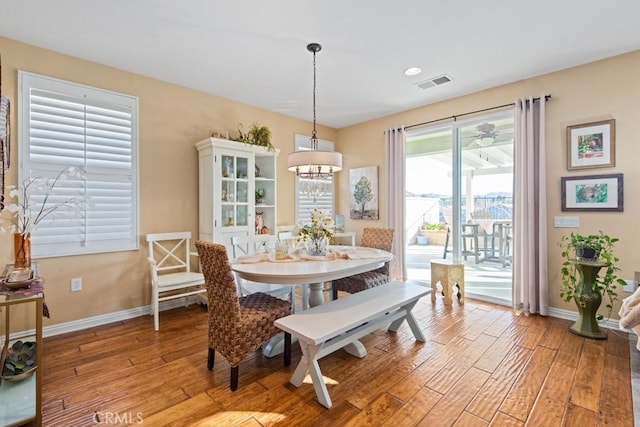 dining room with a chandelier and light hardwood / wood-style flooring