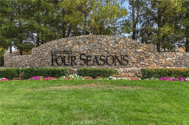 community / neighborhood sign with a lawn