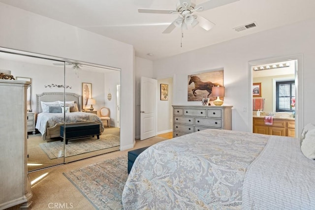 carpeted bedroom with ceiling fan and a closet