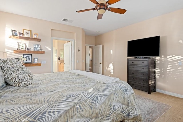 bedroom featuring ceiling fan, light carpet, and connected bathroom