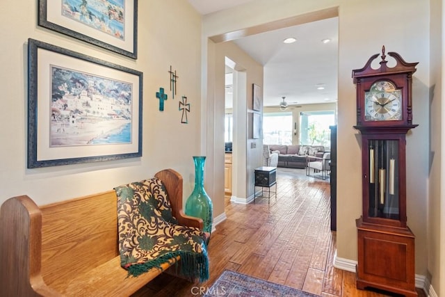 corridor with hardwood / wood-style flooring