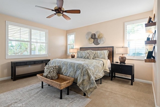 bedroom with ceiling fan and light carpet