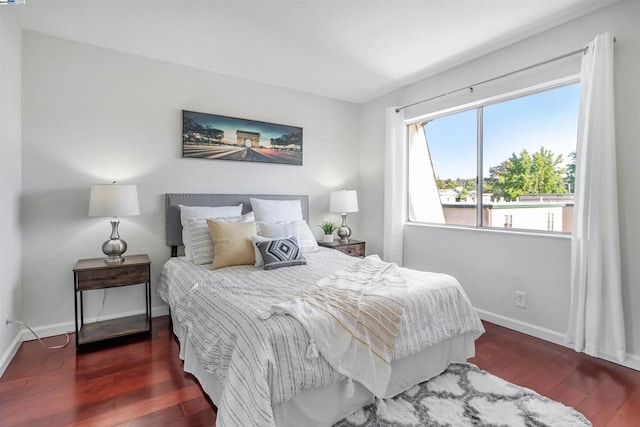 bedroom with dark hardwood / wood-style flooring