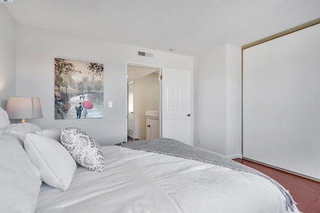 bedroom with a closet and hardwood / wood-style floors