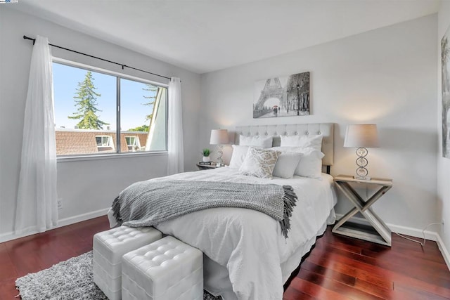 bedroom with dark hardwood / wood-style flooring