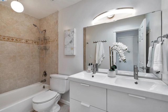 full bathroom featuring toilet, tiled shower / bath combo, tile patterned floors, and vanity