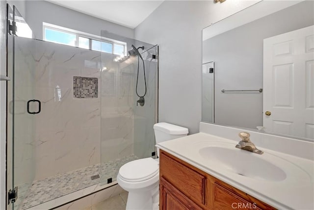 bathroom with walk in shower, vanity, tile patterned floors, and toilet