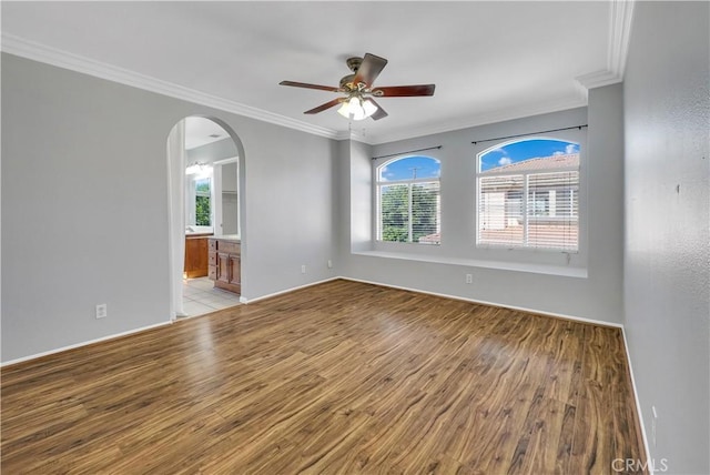 spare room featuring ceiling fan, light hardwood / wood-style flooring, and crown molding