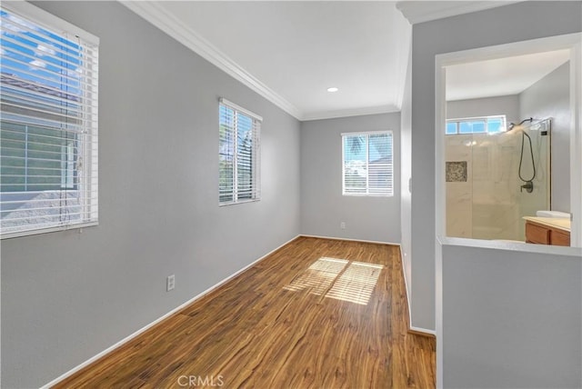 interior space featuring crown molding and hardwood / wood-style flooring