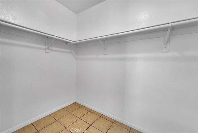 spacious closet featuring light tile patterned floors