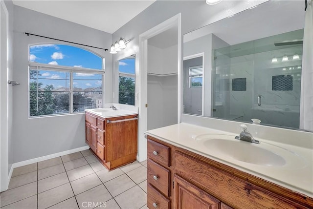 bathroom featuring vanity, tile patterned flooring, and a shower with door