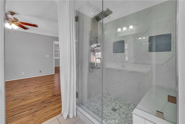 bathroom featuring a shower with shower door, tile patterned flooring, crown molding, and ceiling fan