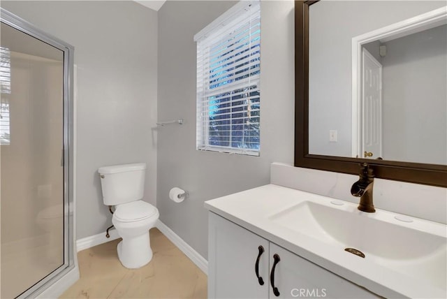 bathroom with a shower with door, a wealth of natural light, toilet, and vanity