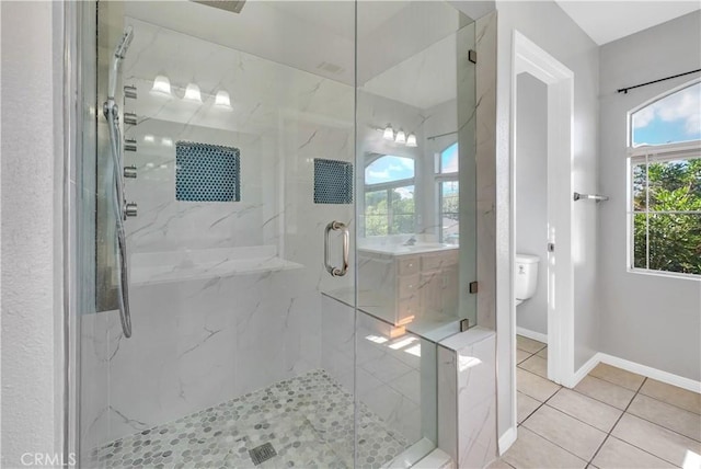 bathroom featuring sink, tile patterned floors, an enclosed shower, and toilet