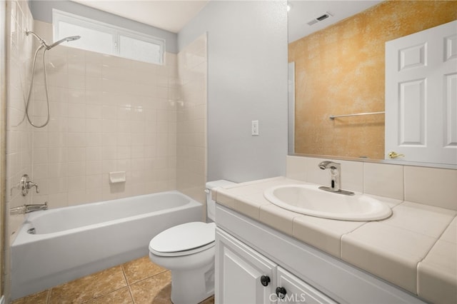 full bathroom with tiled shower / bath combo, tile patterned flooring, vanity, tasteful backsplash, and toilet