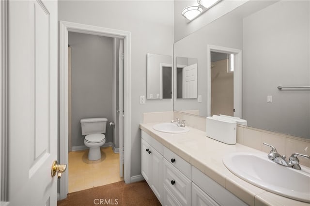 bathroom with toilet and vanity