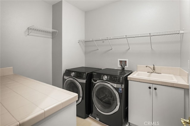 laundry area featuring sink and washing machine and dryer