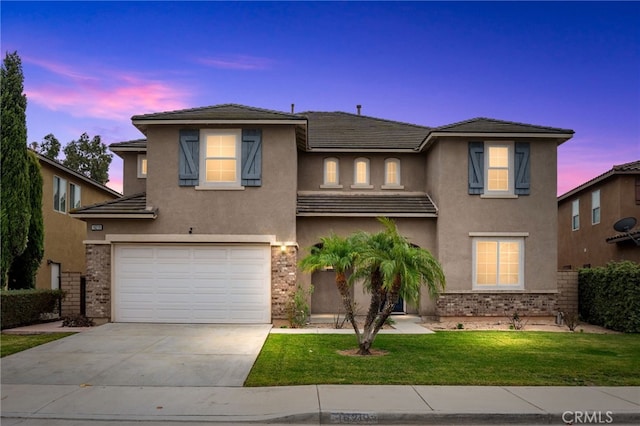 view of front of home featuring a yard and a garage