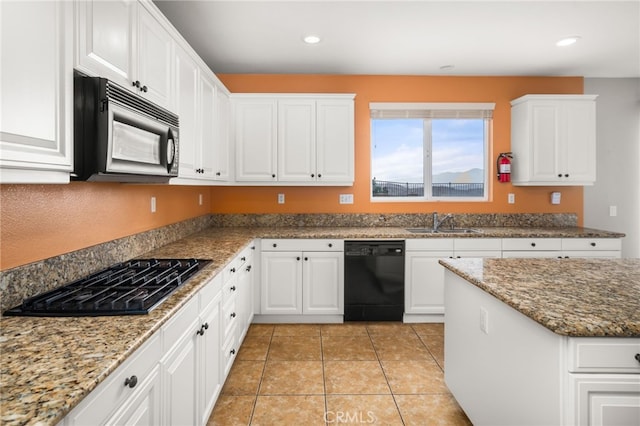 kitchen featuring white cabinets, black appliances, sink, stone countertops, and light tile patterned floors