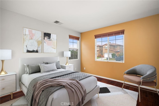 bedroom with dark hardwood / wood-style floors