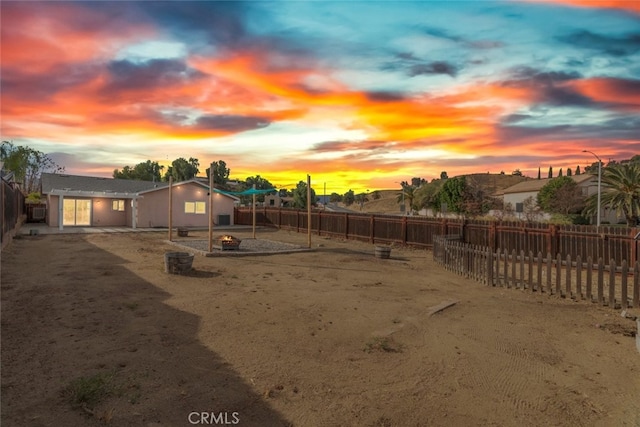 yard at dusk with a patio area