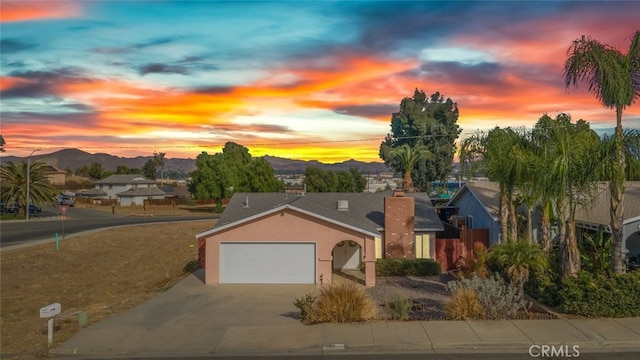 view of front of home with a mountain view and a garage