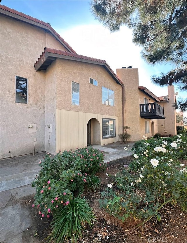 back of house featuring a patio area and a balcony