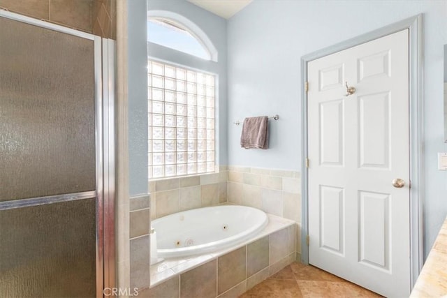 bathroom featuring tile patterned flooring, a wealth of natural light, and independent shower and bath