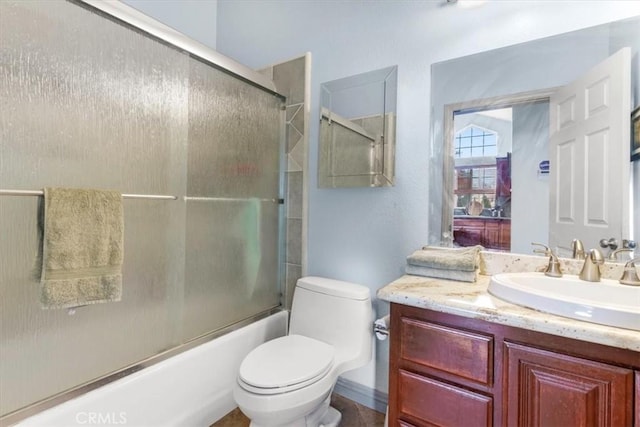 full bathroom with toilet, bath / shower combo with glass door, and vanity