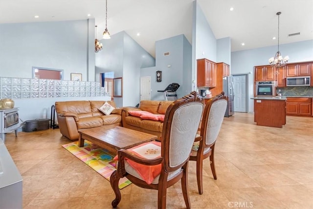 living room with high vaulted ceiling and a chandelier