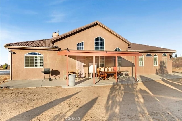 rear view of house with outdoor lounge area and a patio