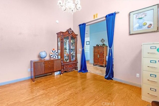 bedroom featuring light hardwood / wood-style floors and an inviting chandelier