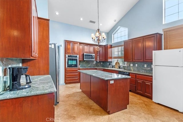 kitchen featuring stainless steel appliances, backsplash, high vaulted ceiling, a kitchen island, and light stone counters