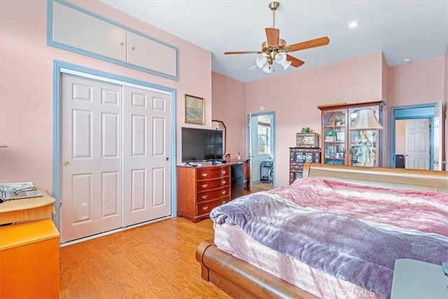 bedroom featuring ceiling fan, a closet, and light wood-type flooring