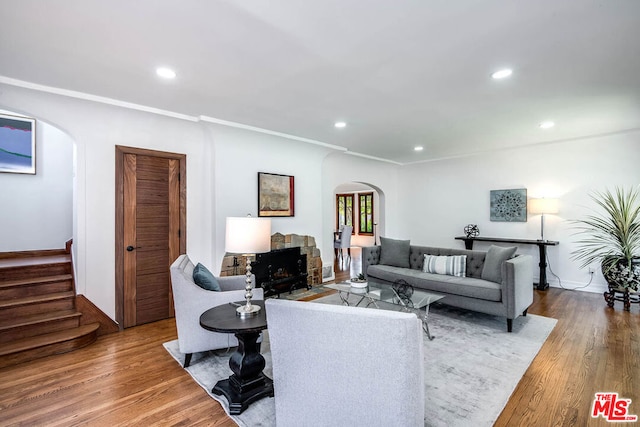 living room featuring hardwood / wood-style flooring and ornamental molding