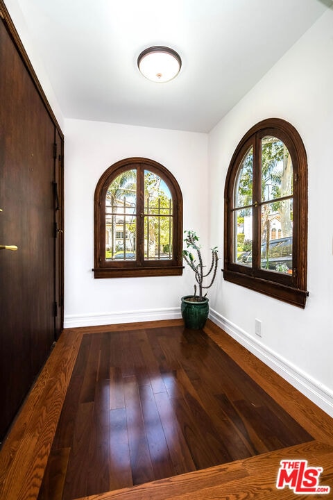 empty room with french doors and hardwood / wood-style flooring