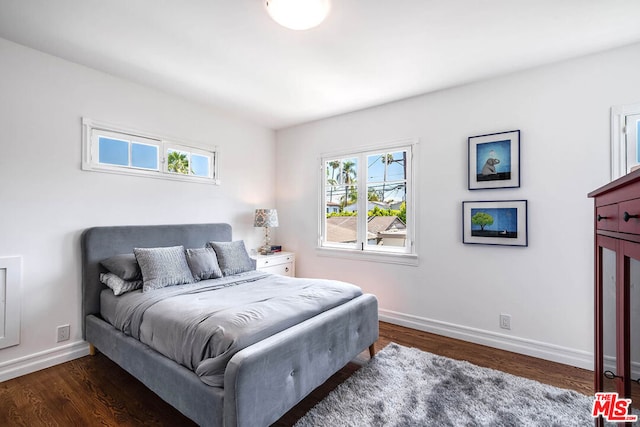 bedroom featuring dark hardwood / wood-style floors and multiple windows