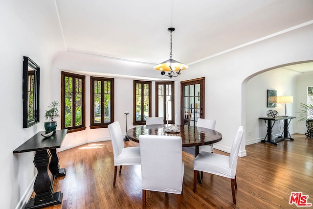 dining room featuring dark hardwood / wood-style floors and a notable chandelier