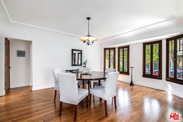 dining room featuring hardwood / wood-style flooring and an inviting chandelier